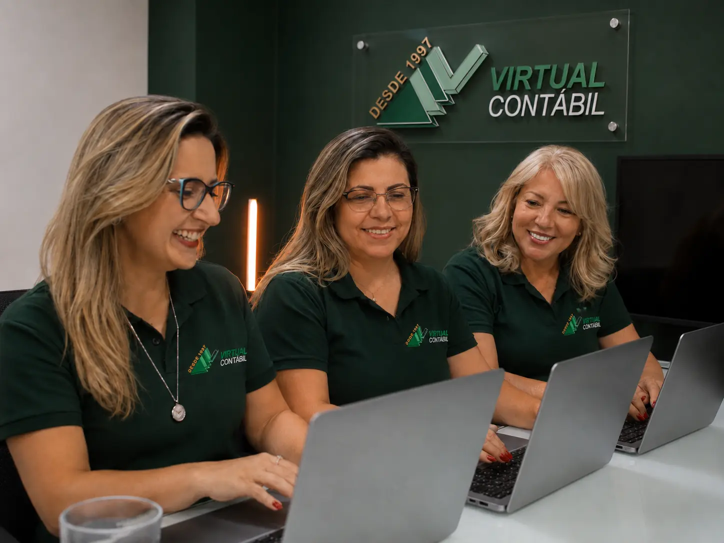 Três profissionais da equipe Virtual Contábil trabalhando juntas
